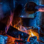 In Cerentino kann man im aufwendig renovierten historischen Patrizierhaus Cà Vegia wohnen, mit jahrhundertealten Originalmöbeln, aber ohne Strom. Polenta wird über dem offenen Feuer zubereitet, Circolo della Rovana, Schweiz / © Foto: Georg Berg